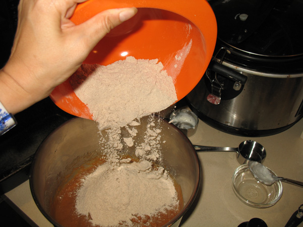 adding dry ingredients to the bowl