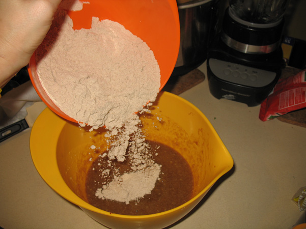 adding dry ingredients to wet
