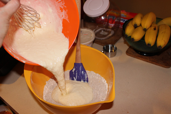pouring mixture into flour