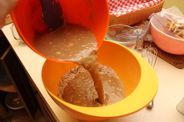 pouring liquid into dry ingredients